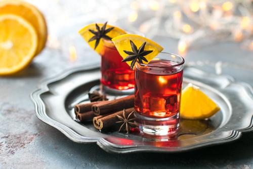 Glass of spiced rum with cinnamon sticks